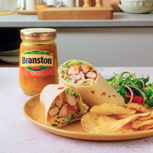 Shrimp wrap with chips and Branston Chilli on a plate