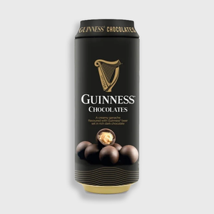 A single can of Guinness Chocolates centered on a light gray background. The can is predominantly black with gold and white branding, including the Guinness harp logo, the words 'GUINNESS CHOCOLATES,' and an image of chocolate truffles near the bottom.