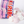 A bag of Haribo Chamallows pink and white marshmallows with several pink and white marshmallows spilled out on a white background.