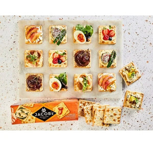 Jacobs cream crackers with various toppings on a textured surface