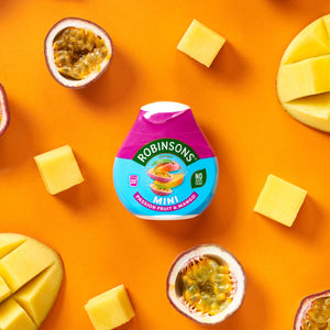 Robinsons Passion Fruit & Mango squash drink container surrounded by fruit on an orange background