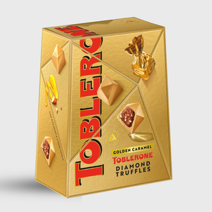 Gold Toblerone packaging with diamond truffles on a white background