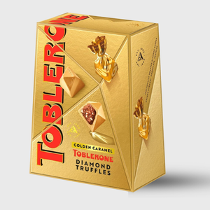 Gold Toblerone packaging with truffles on a white background