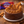 Chocolate cake with Biscoff cookies on a wooden surface with Cadbury Dairy Milk and Biscoff packaging.