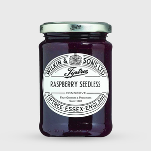 Jar of raspberry seedless conserve with a white label on a light gray background
