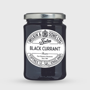 Jar of Tiptree Black Currant Preserve with a white label on a light gray background
