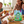 Family gathered around a table with a bowl of Fruit Pastilles Squidgers and a package of the product.