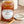 Jar of Tiptree Apricot Preserve with a wooden spoon on a wooden surface