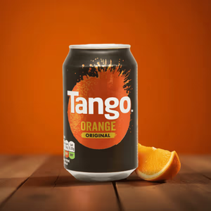 A can of Tango Orange Original soda on a wooden surface with an orange slice beside it, set against a solid orange background.