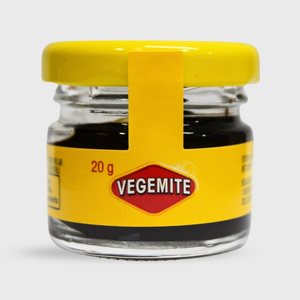 Small jar of Vegemite with a yellow lid and label on a white background