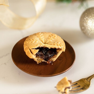 Pastry on a wooden plate with festive decorations in the background