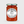 Jar of Tiptree apricot preserve with a white label on a light gray background