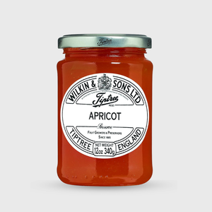 Jar of Tiptree apricot preserve with a white label on a light gray background