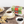 Yorkshire Tea box with a cup of tea, cookies, and blueberries on a wooden table.