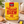 A yellow box of Yorkshire Tea Malty Biscuit Brew tea bags stands on a tabletop with a teapot, cookies, and a tea bag nearby, suggesting a cozy tea-time setting.